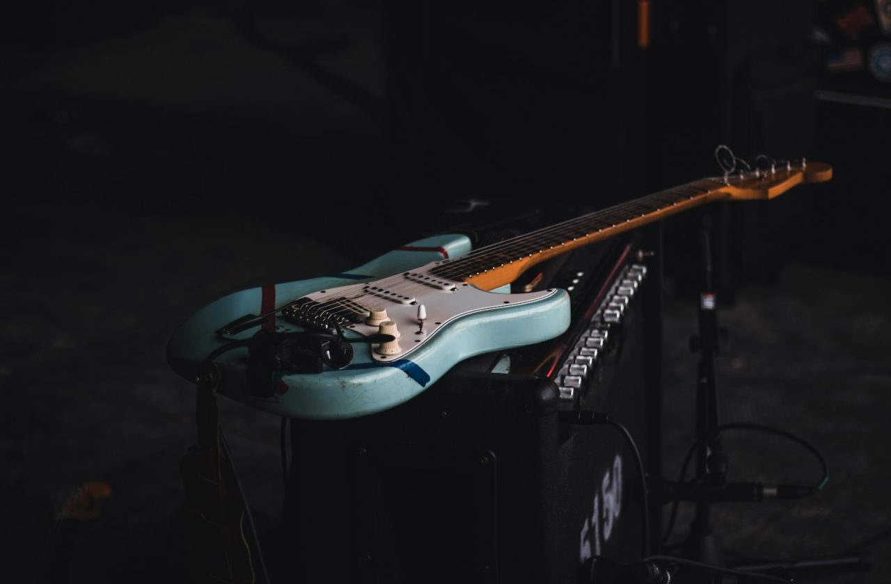 teal and brown electric guitar
