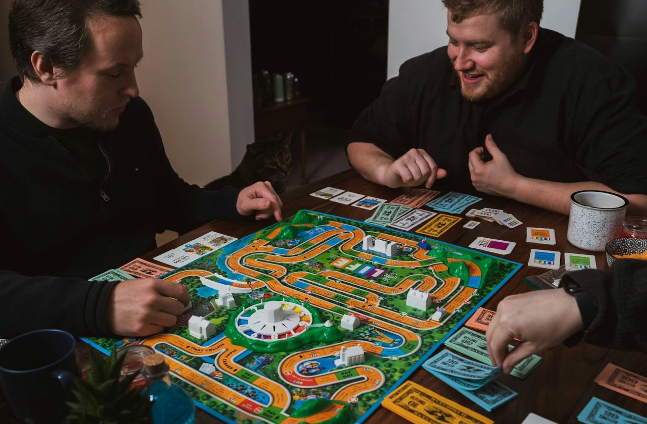 two men playing a game of monopoly on a table