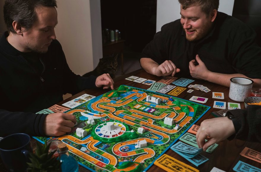 two men playing a game of monopoly on a table