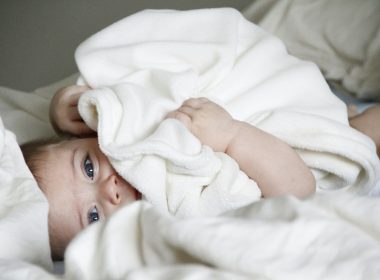 baby laying on bed