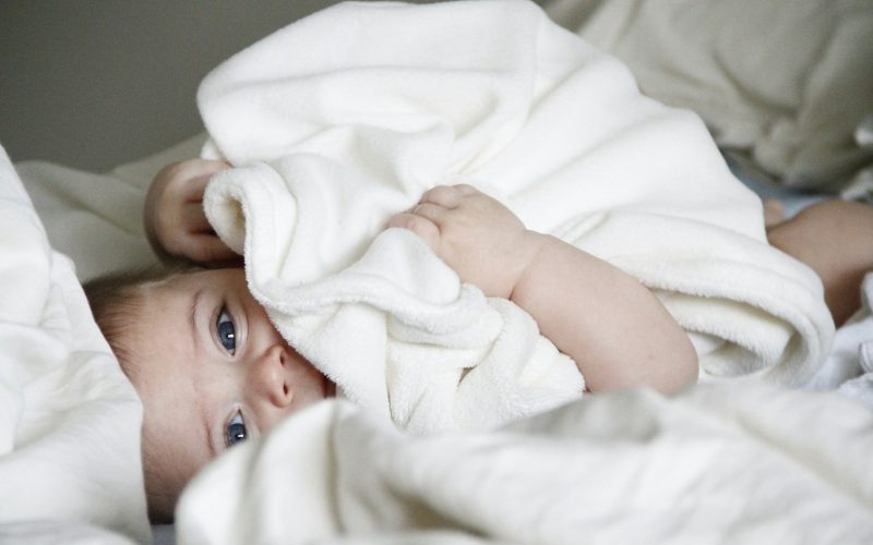 baby laying on bed