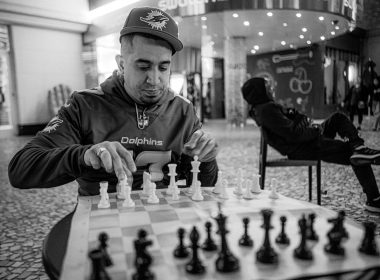 a man playing a game of chess in a mall