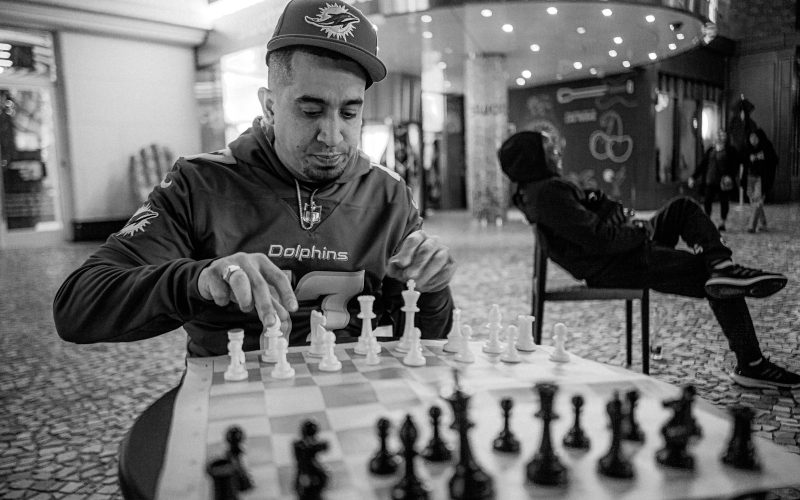 a man playing a game of chess in a mall