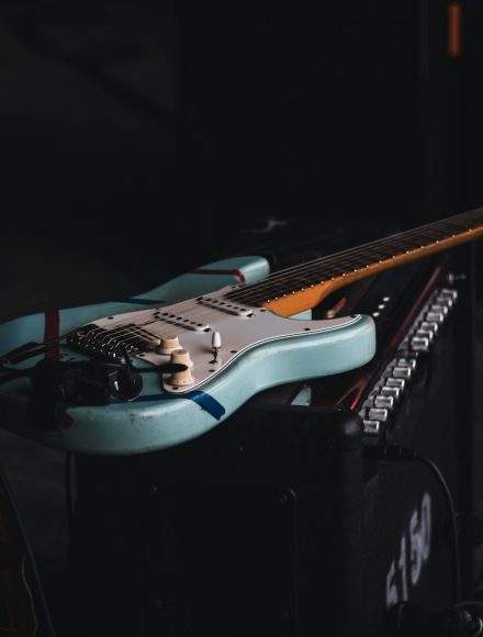 teal and brown electric guitar