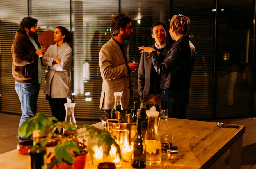 five person standing while talking each other